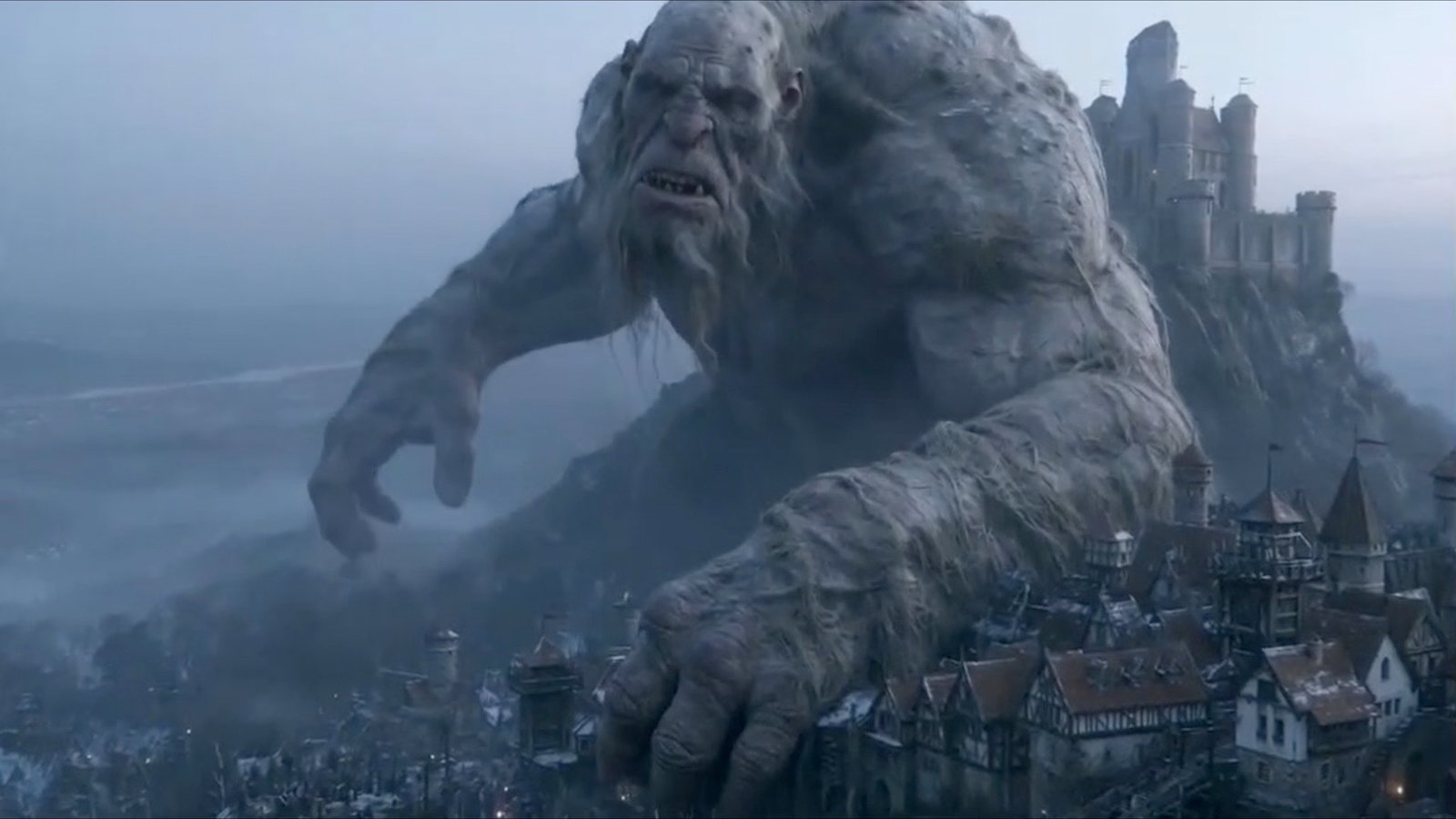 A giant creature climbs over a castle town — still from the Pelisson Production showreel
